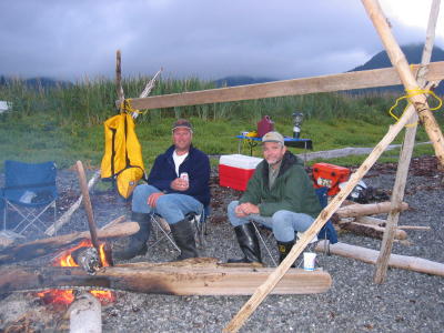 Jeff and John sit next to the fire in Port Chatham